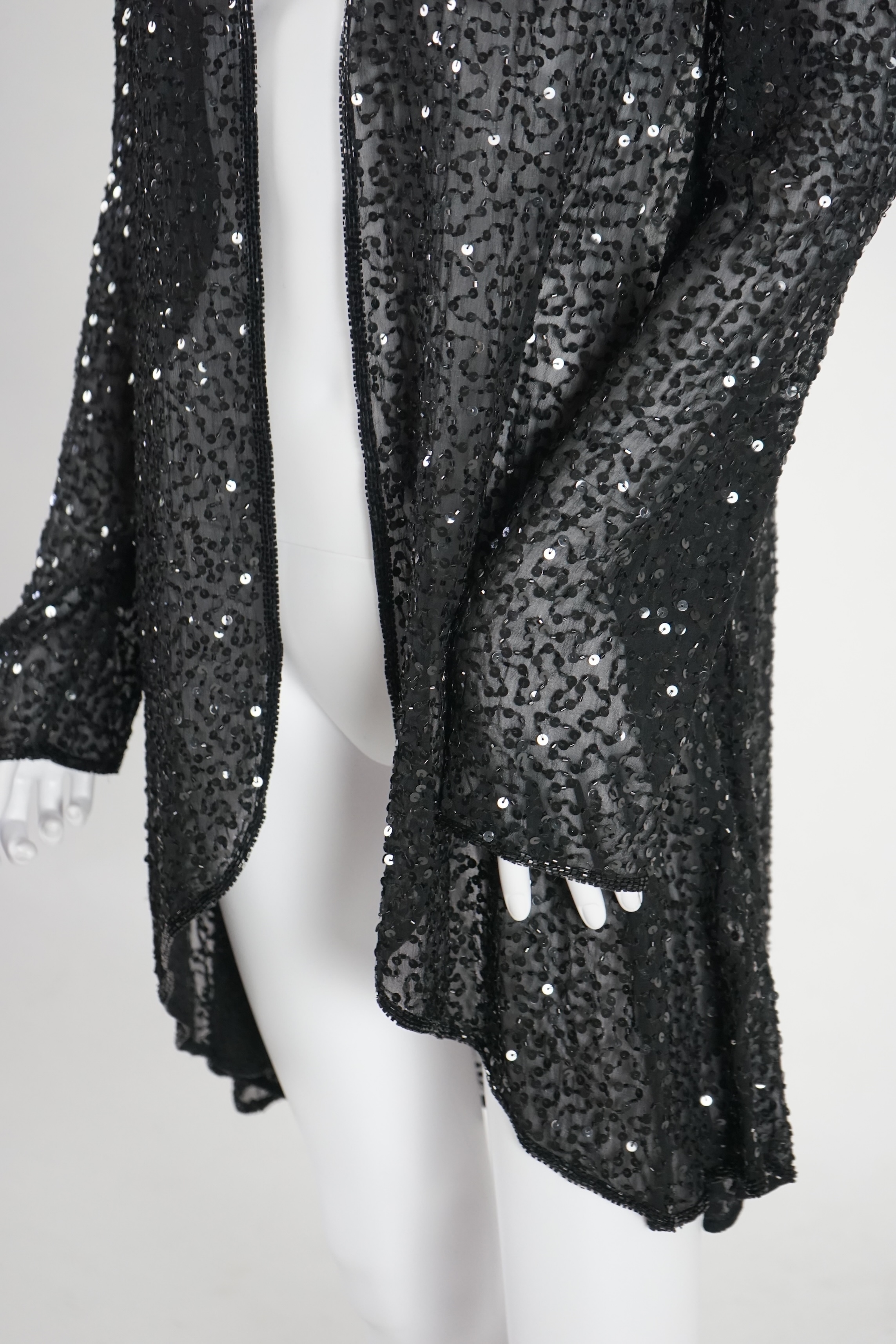 A selection of lady's evening tops and jackets, all black with sequin embellishments, six pieces in total. Proceeds to Happy Paws Puppy Rescue